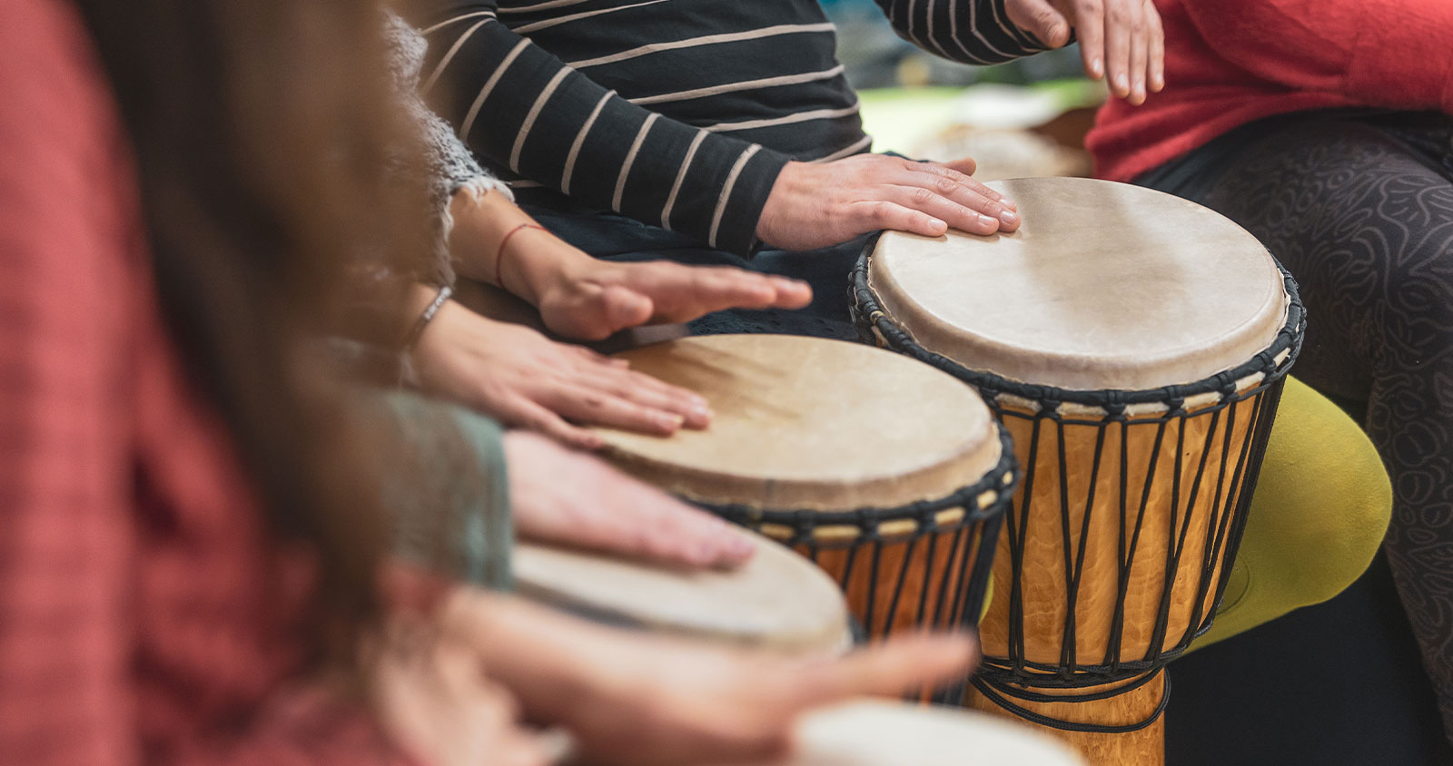 People drumming together